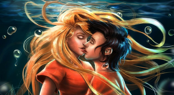 Couple kissing underwater with flowing hair