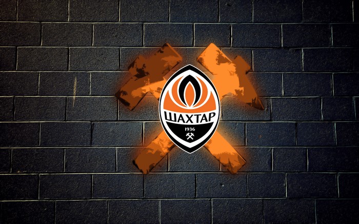 FC Shakhtar logo on a brick wall