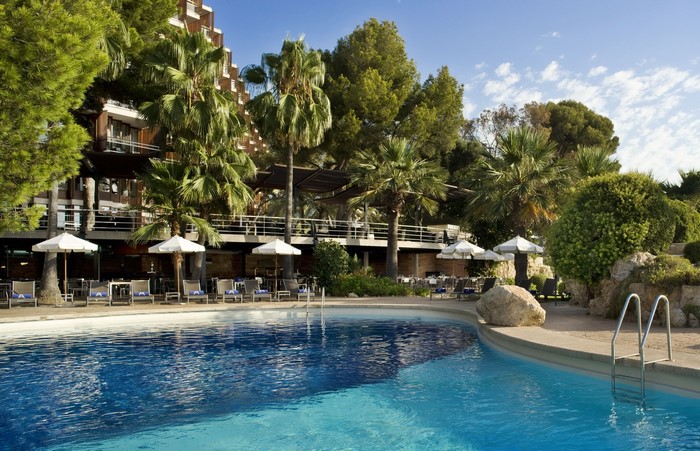 Resort pool with palm trees and hotel in Majorca, Spain