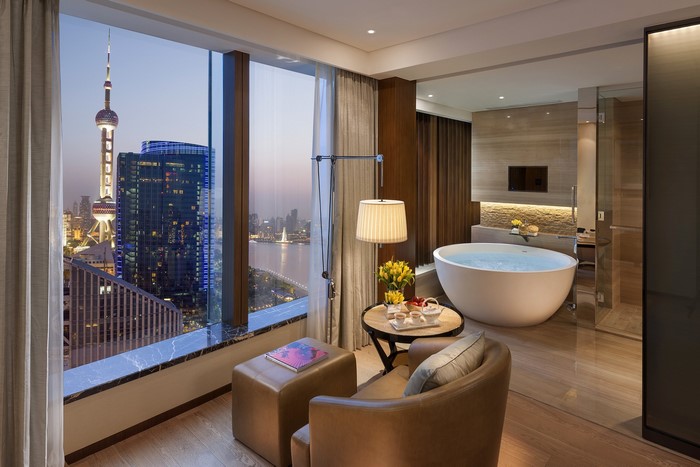 Luxury hotel room with city view and bathtub