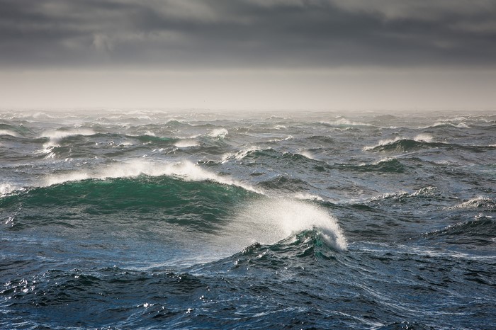 Rough sea with large waves under a cloudy sky