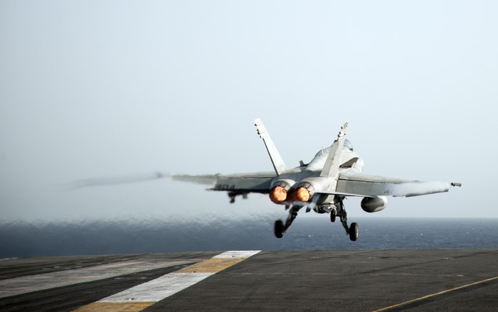 Fighter jet taking off from aircraft carrier