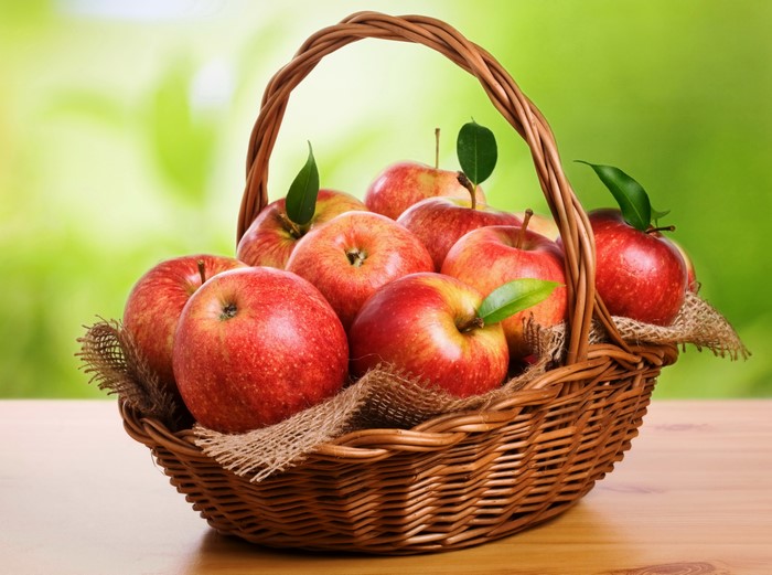 Basket of Red Apples with Green Background