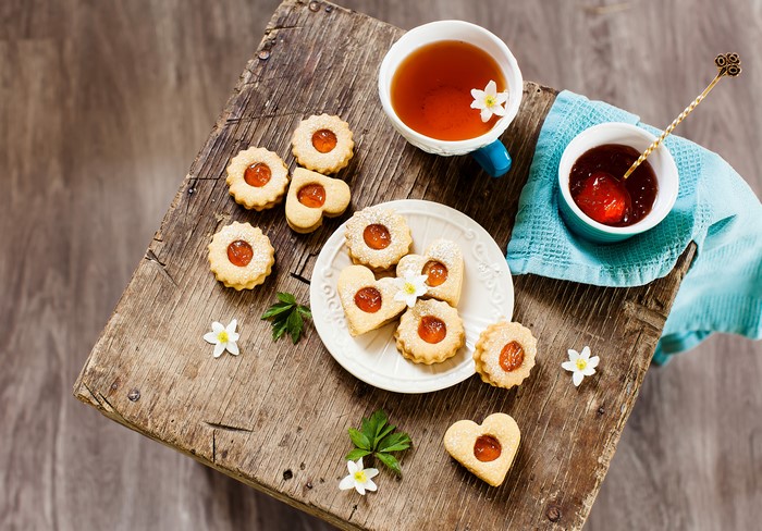 Tea and cookies with jam on a wooden table