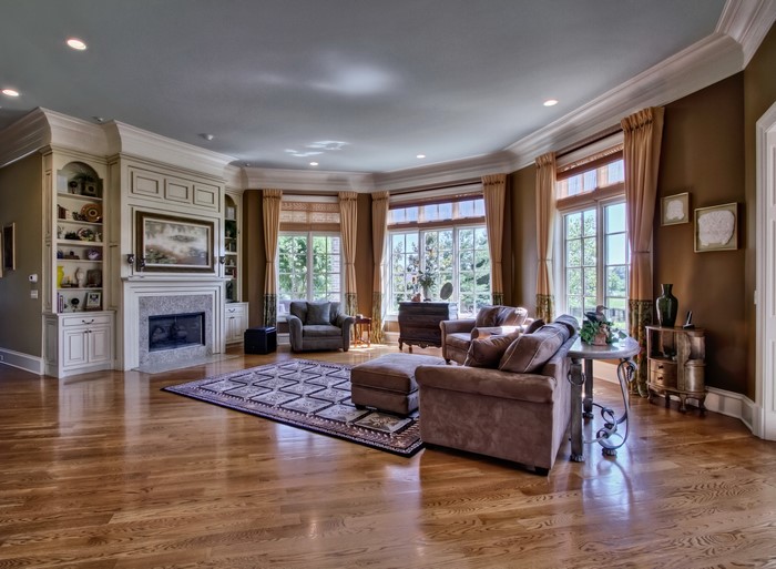 Living room with fireplace, sofa, and armchairs