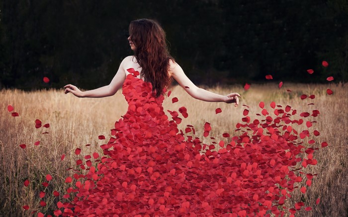 Woman in a dress made of red petals