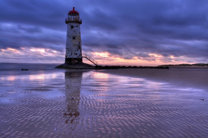 Lighthouse on a beach at dusk, United Kingdom
