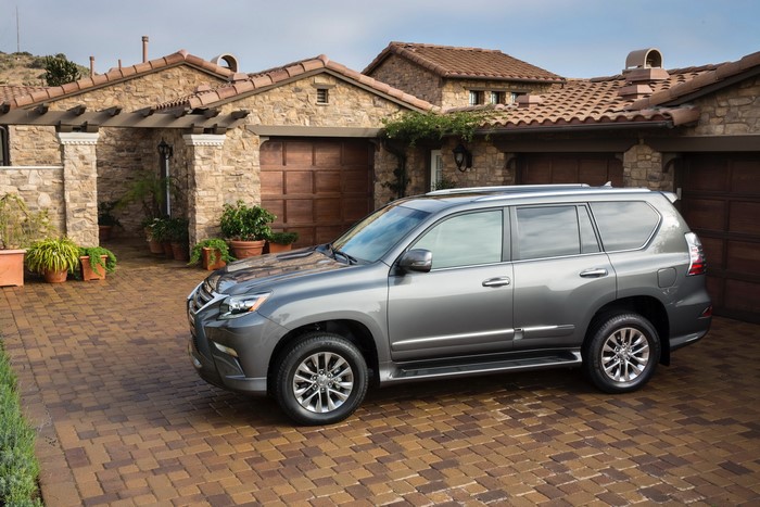 Grey Lexus GX 460 parked in front of a stone house