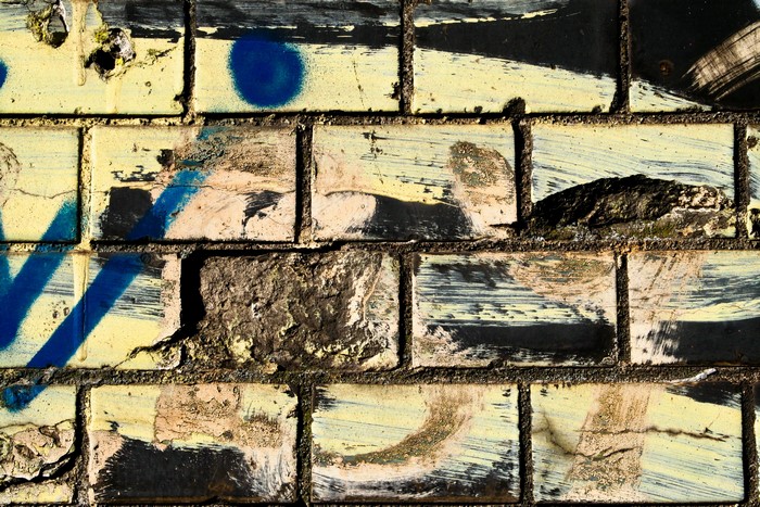 Graffiti on a weathered brick wall