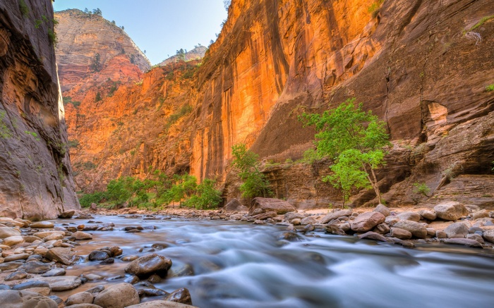 River flowing through a canyon with orange cliffs