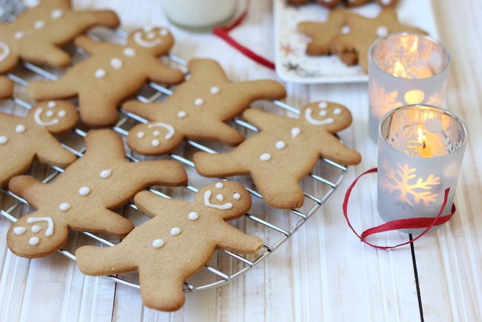 Gingerbread cookies on a cooling rack with candles
