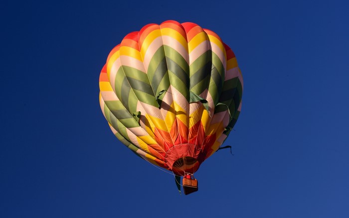 Colorful hot air balloon against a clear blue sky