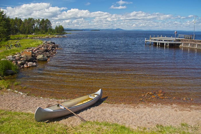 Canoe and Paddle on a Sandy Shore by a Lake in Dalarna, Sweden