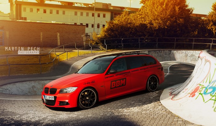 Red BMW 330d E91 Wagon in Skatepark