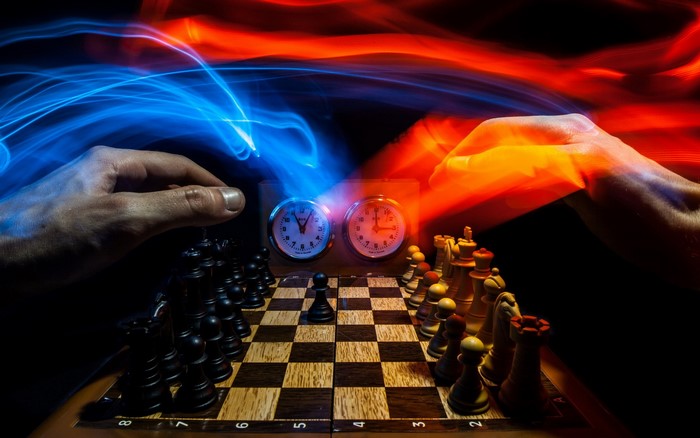 Chess game with light streaks and hands