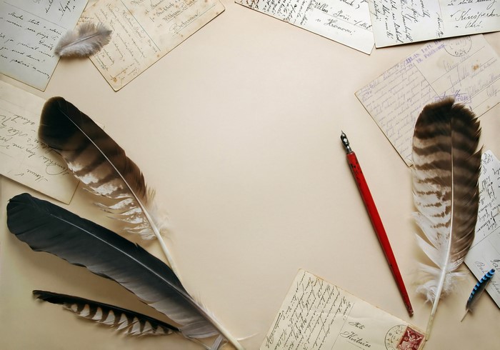 Feathers and old letters with a quill pen