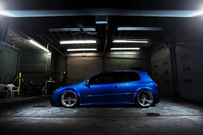 Blue Volkswagen Golf GTI in a garage