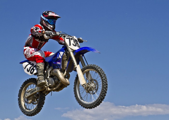 Motocross rider in mid-air on a Yamaha motorcycle