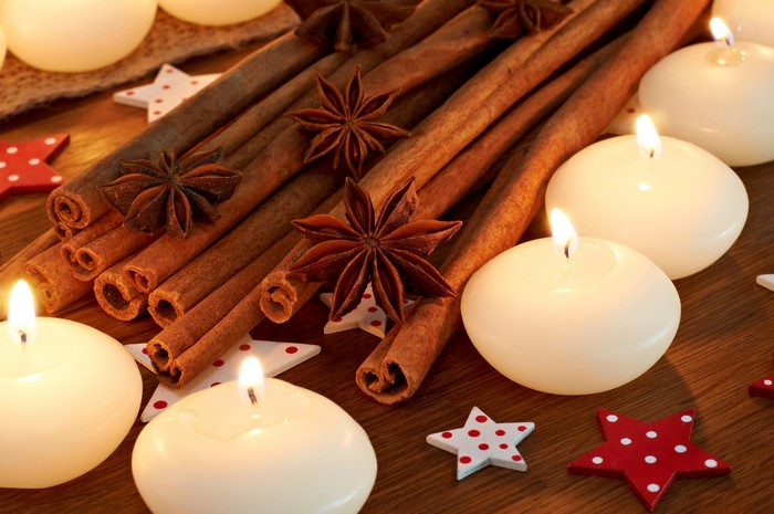 Cinnamon sticks, star anise, and floating candles with stars