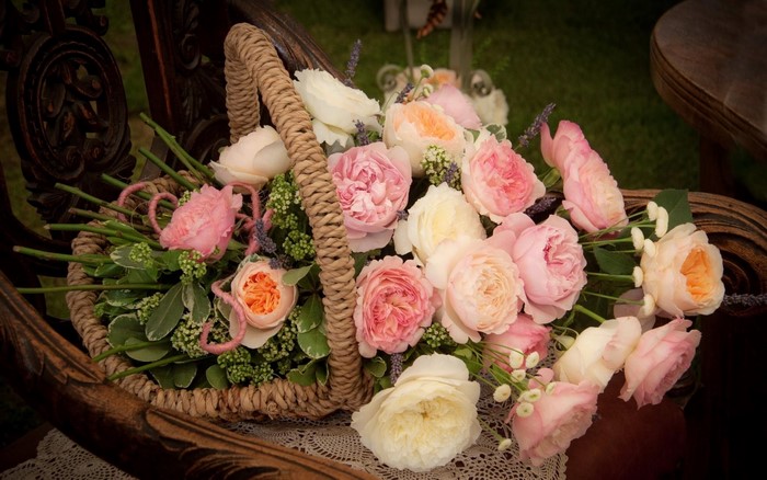 Roses in a wicker basket on a chair