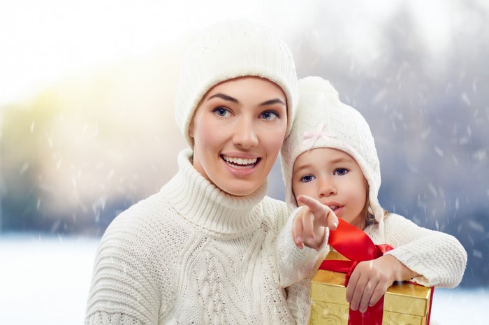Mother and child with Christmas gift in winter
