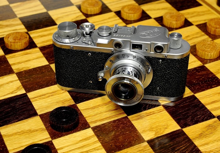 Vintage camera on a checkerboard with checkers