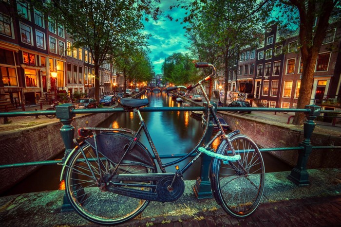 Bicycle on a bridge over a canal in Amsterdam