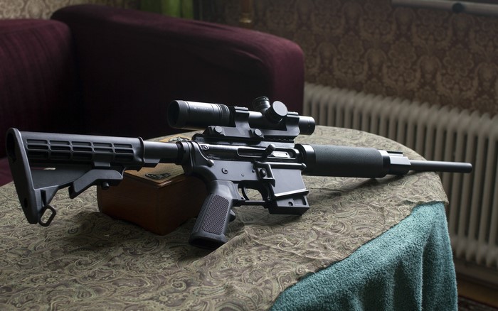 Assault rifle with scope on a table