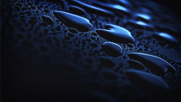 Close-up of many dark blue water drops
