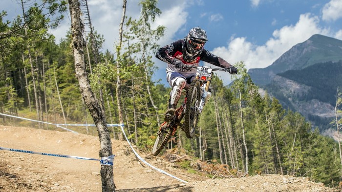 Mountain biker jumping over a dirt track