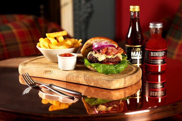 Hamburger with fries and condiments