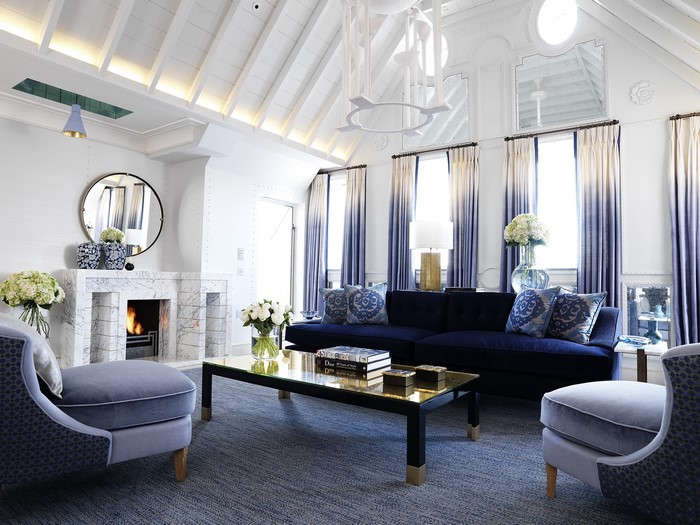 Luxury living room with fireplace and blue sofa