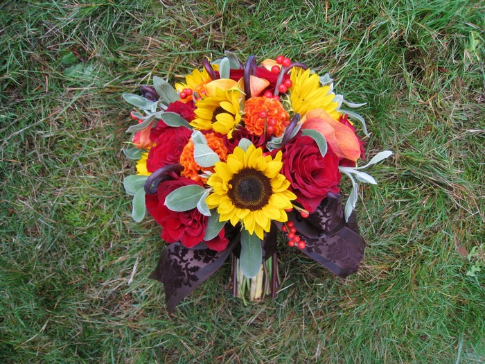 Autumn bouquet with sunflowers and roses on grass