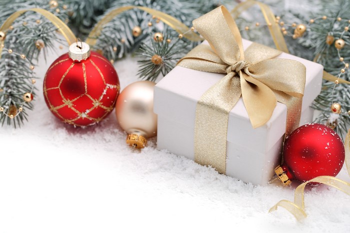 Christmas gift with ornaments and pine branches