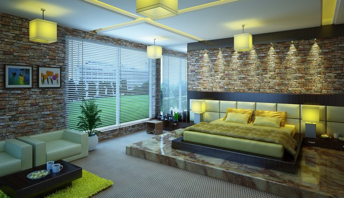 Modern bedroom with stone walls and a raised bed