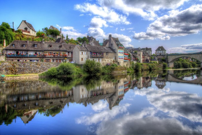 Riverfront houses and bridge in Argentat, France