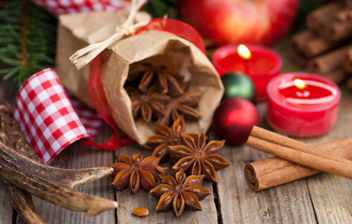 Christmas spices with candles and apple
