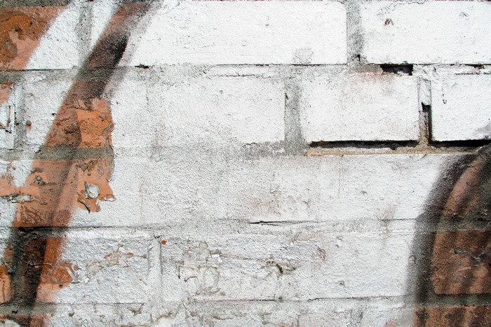 Graffiti on a white brick wall