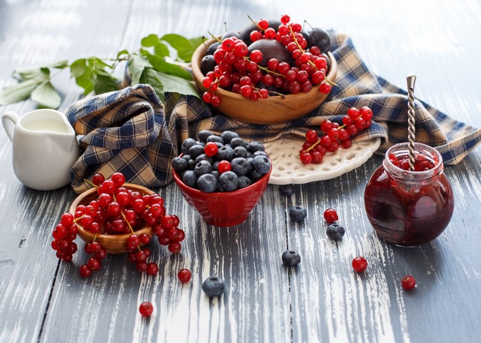 Berries and jam on a wooden table
