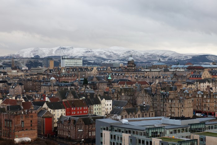 Edinburgh cityscape with snow-capped mountains