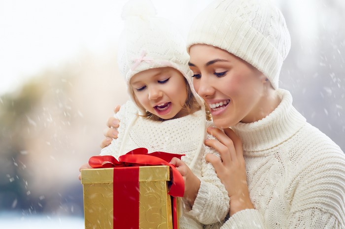 Mother and daughter opening a Christmas gift