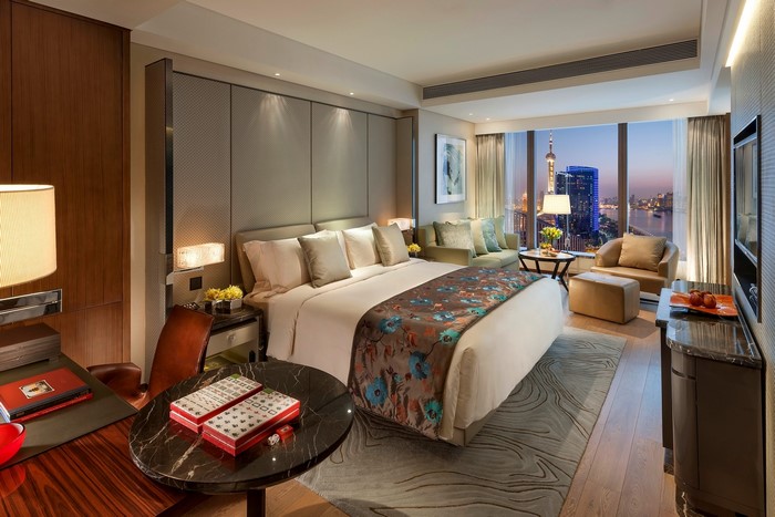 Luxury hotel bedroom with city view