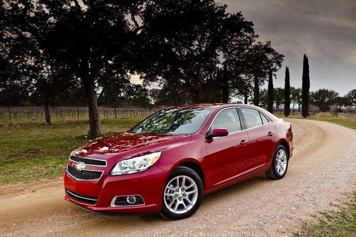 Red 2013 Chevrolet Malibu ECO on a dirt road