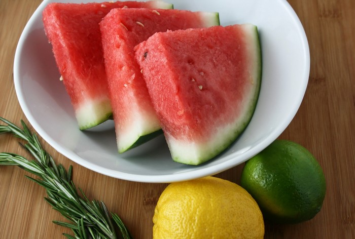 Watermelon slices with lemon, lime, and rosemary