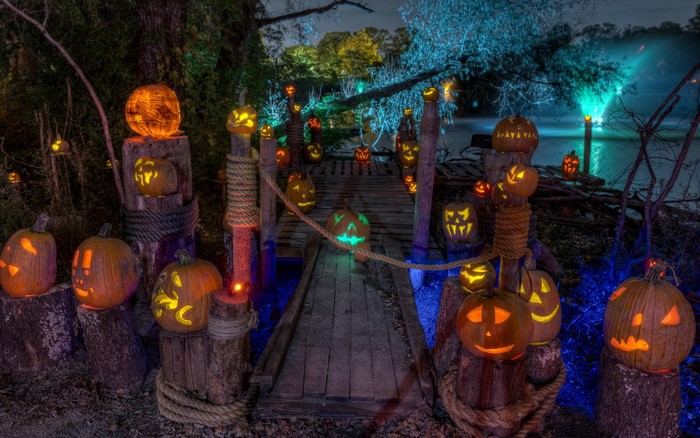 Halloween Night with Carved Pumpkins on a Wooden Dock