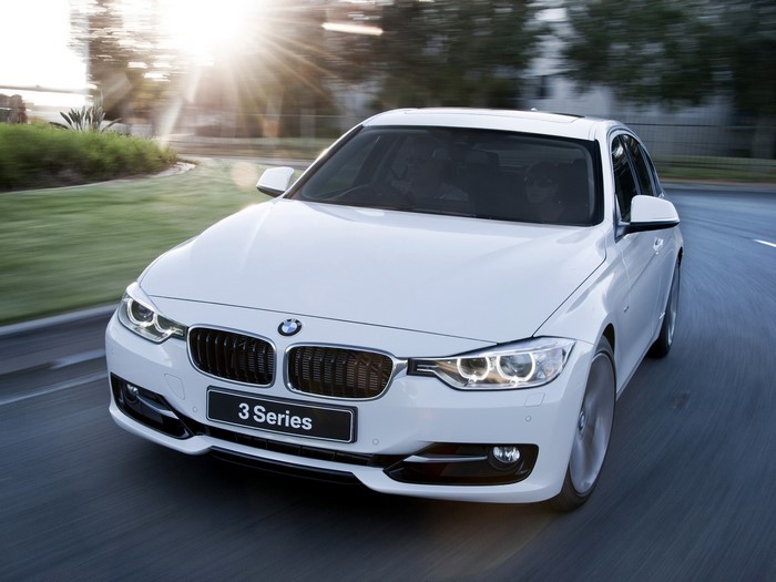 White BMW 3 Series Sedan Driving on Road
