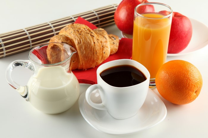 Breakfast with coffee, juice, and fruit