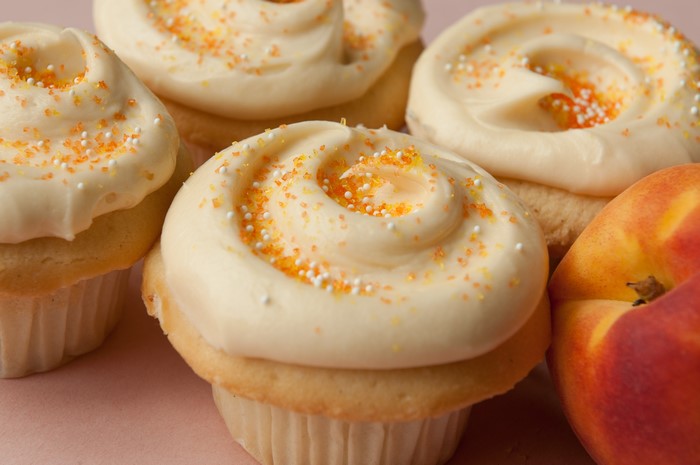 Cupcakes with orange sprinkles and peach