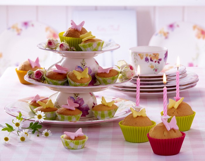 Birthday cupcakes with candles and flowers