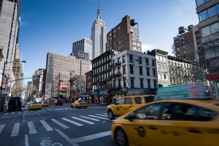 New York City Street with Empire State Building and Taxis